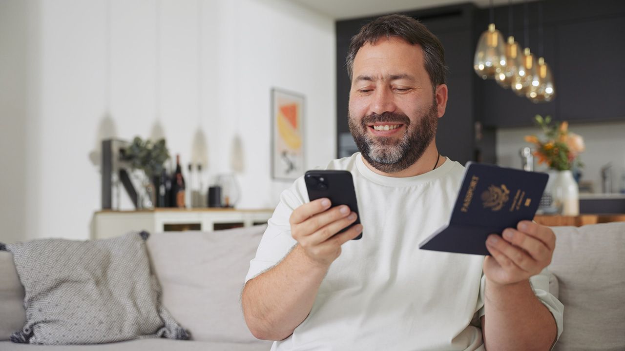 Happy customer scanning passport with mobile device