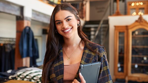 fashion consultant smiling carrying tablet